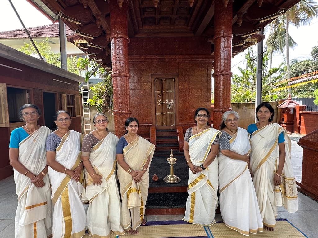 Devotional gathering with musicians performing inside the temple.