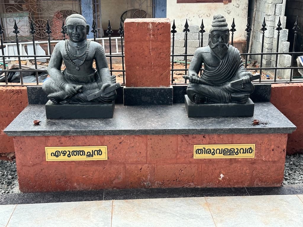 Temple altar featuring Saraswathi Devi and sacred lamps.