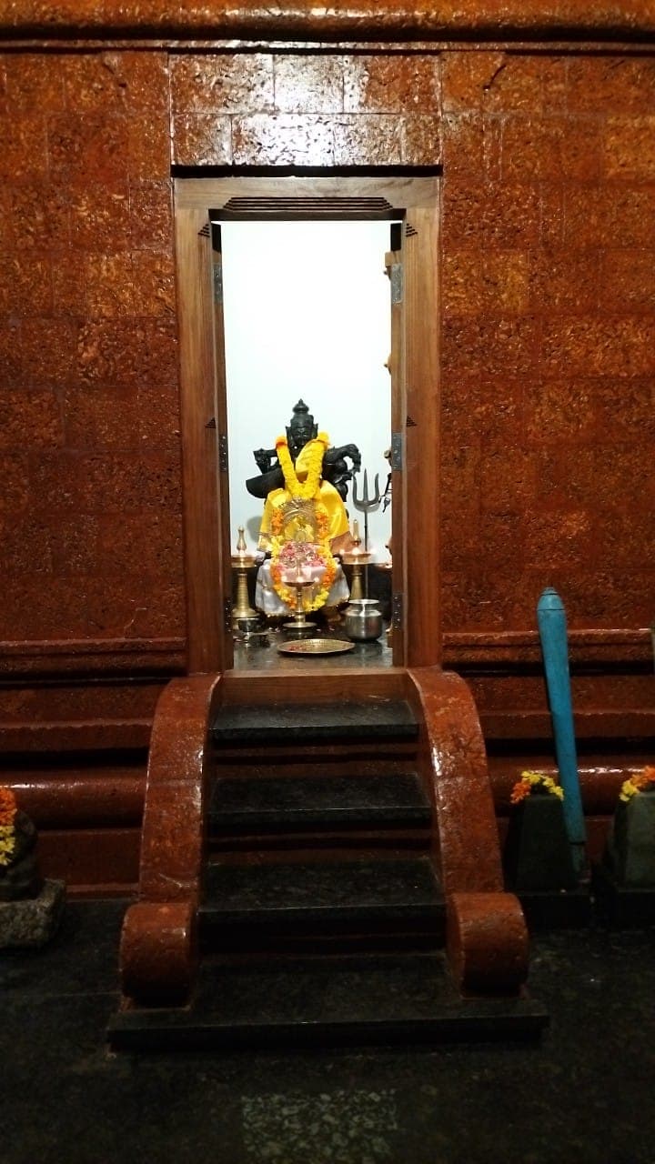 Close view of Saraswathi Devi sanctum decorated with lamps.